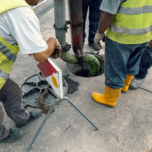 workers hydro jetting a sewer line