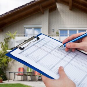 a home inspection checklist in front of a home