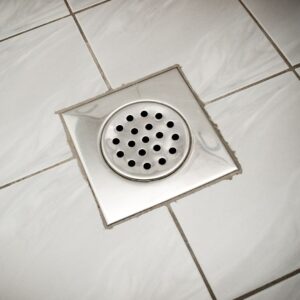 a drain cover on a shower floor