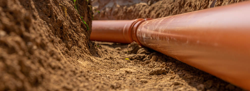 Exposed pipe lines in dug-up soil Renton, WA